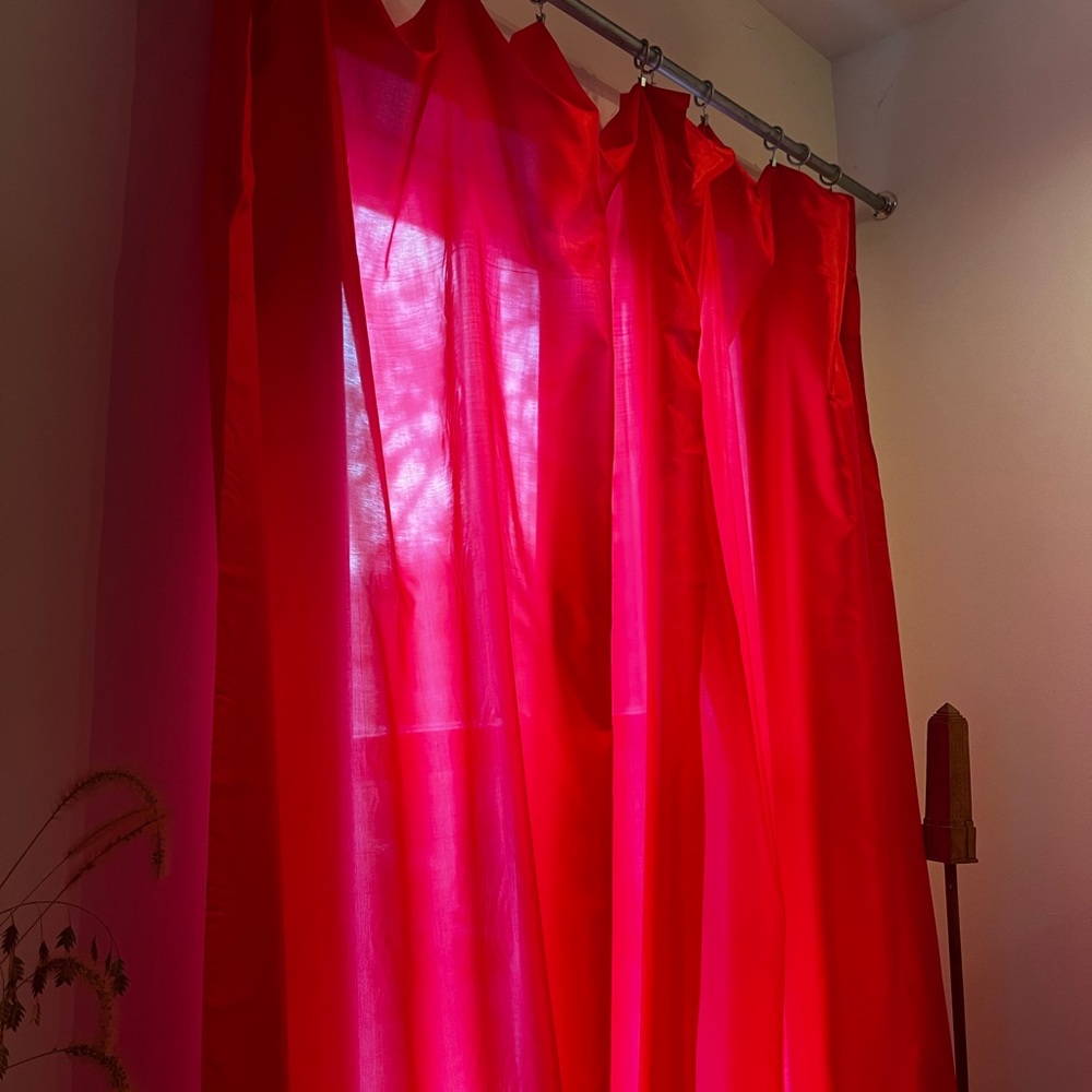 Vibrant semi-sheer curtains in poppy red